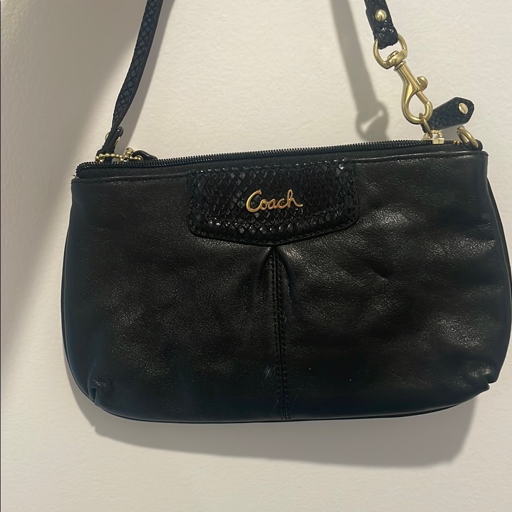 Coach Black with gold script font leather wristlet clutch bag